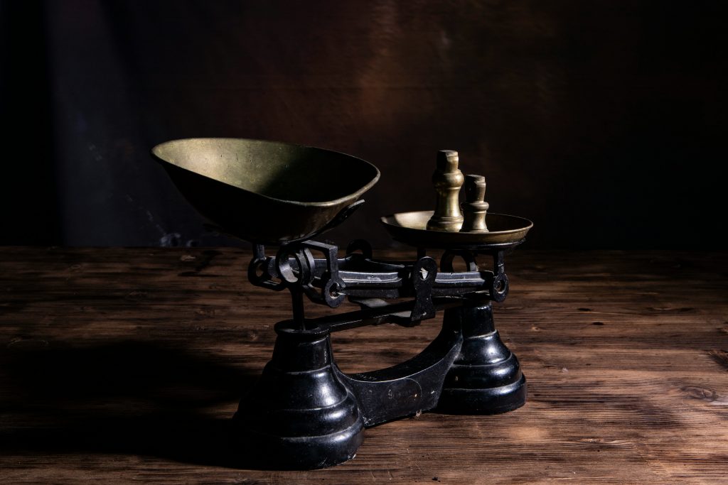 a black scale resting on a wooden table